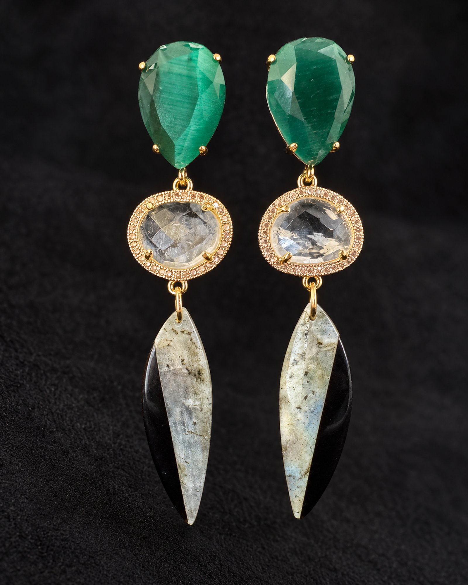 Hanging pair of earrings with green upper sections, gold-toned circular rims and long pointed pale grey drops.
