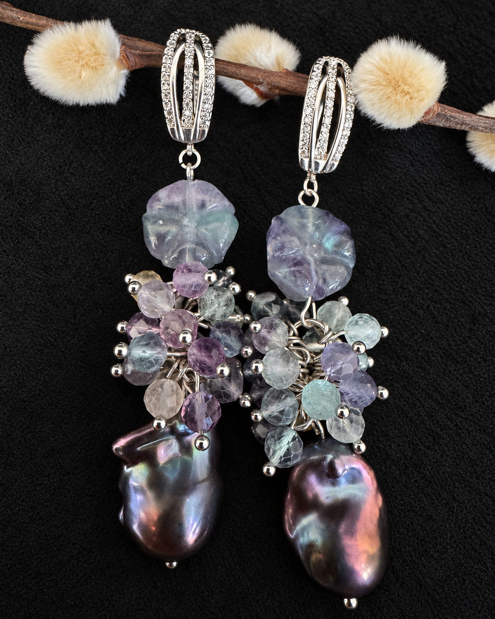 Cropped front view of both earrings, showing pale lavender upper shapes, clustered beads and partial dark drops.