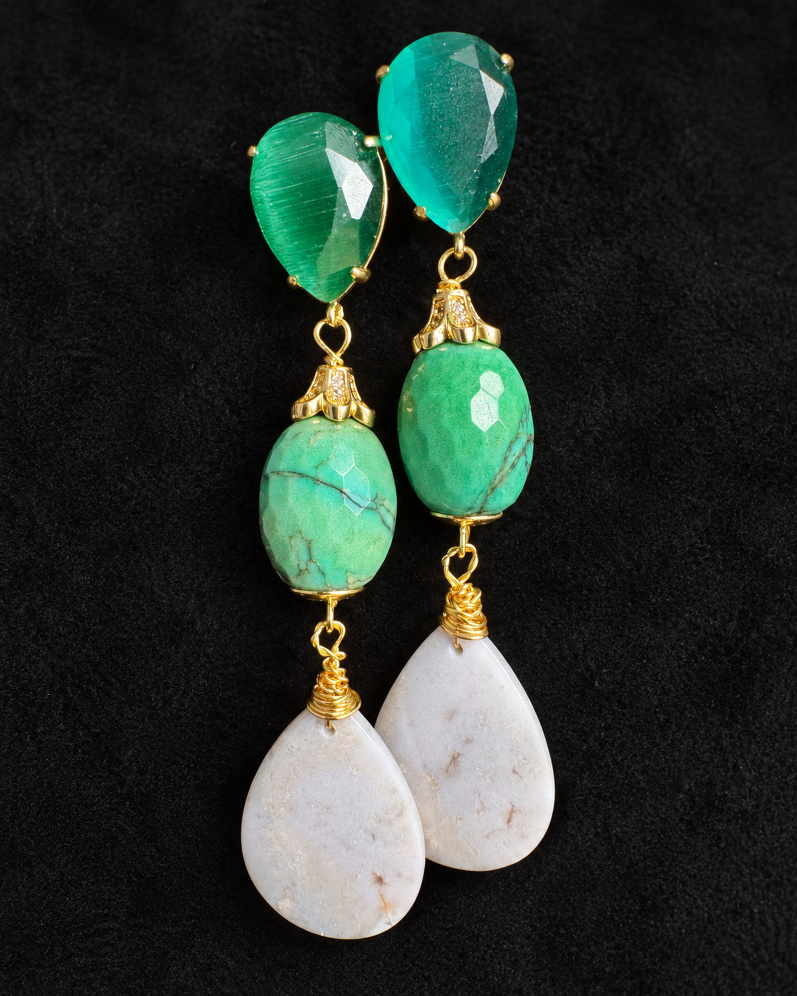 Full hanging view of Clover Portia earrings at staggered heights, showing green upper sections and pale teardrop pendants.