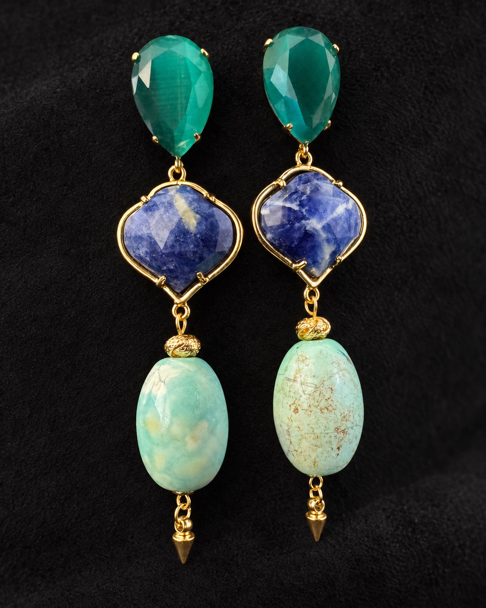 Hanging pair of drop earrings with teal teardrops, blue patterned centres and pale aqua oval drops in gold-toned settings.