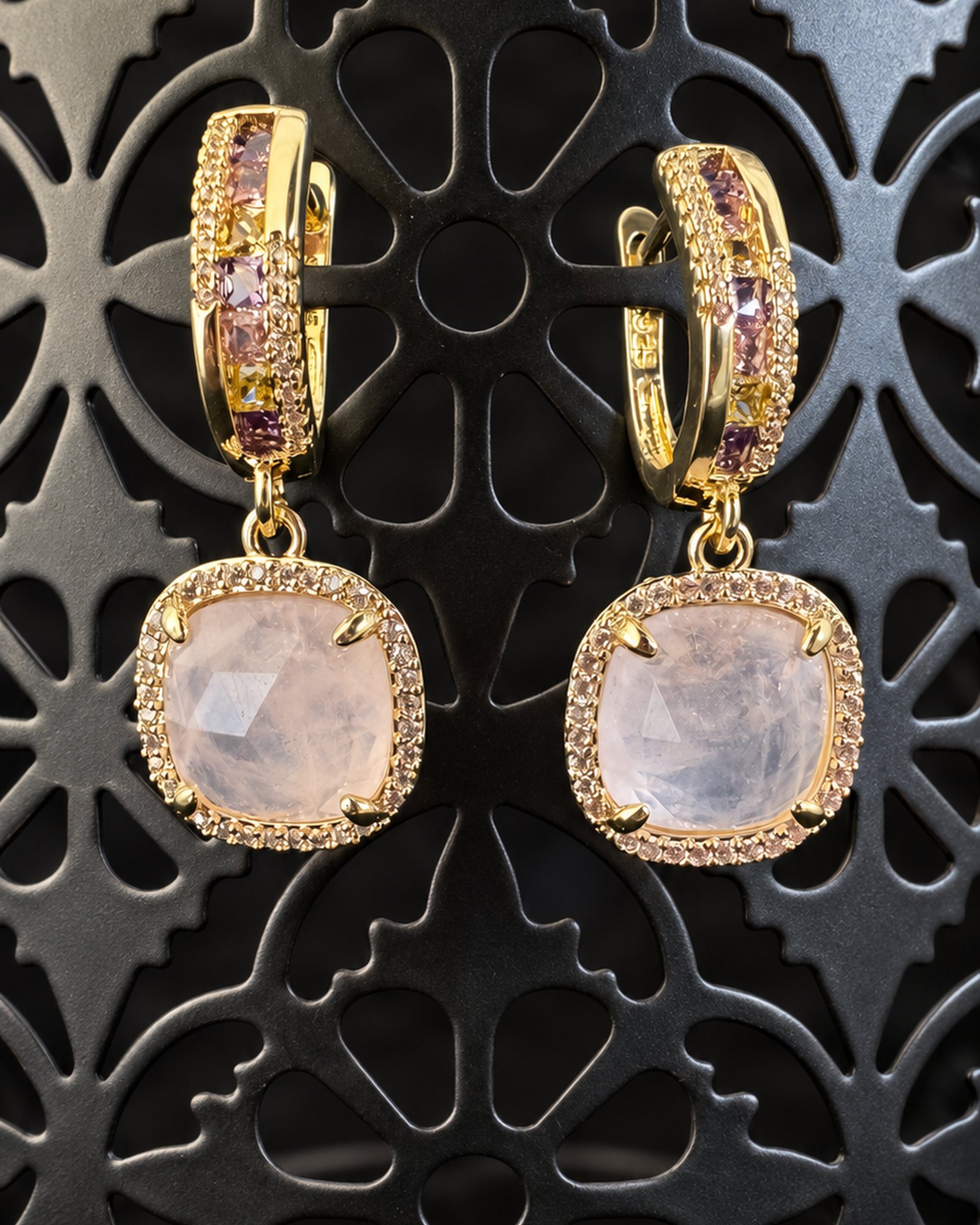 Pair of pale smoky lilac drop earrings with gold-toned hoops on a dark pierced decorative stand.